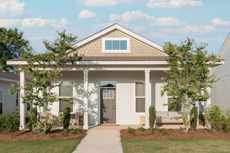 A small house with a front porch and yard, representing Anthem Luxury Rental Homes.