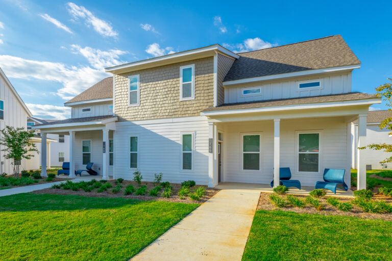 A charming home with a front porch and a well-kept lawn, located at Heartsease in Ocean Isle.