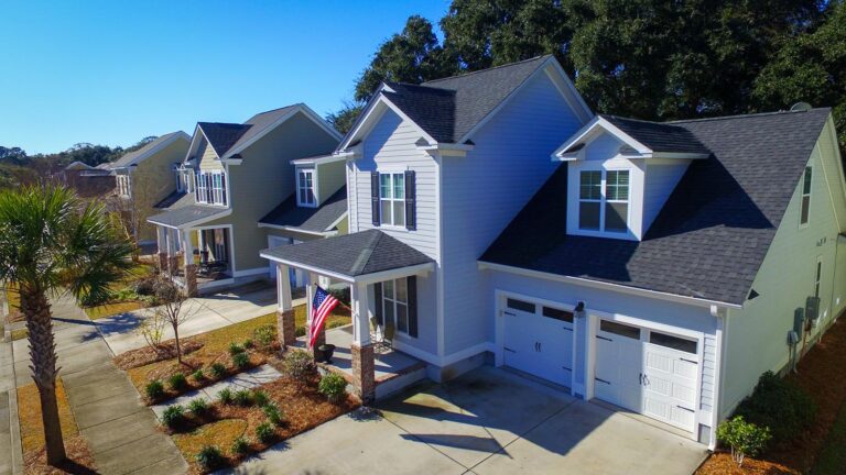 A large home named Eaglewood Retreat featuring two garages and an expansive driveway.