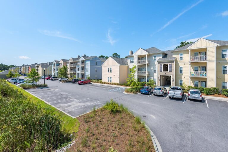 Apartments at Shade Tree, featuring modern architecture and lush landscaping in a serene community setting.